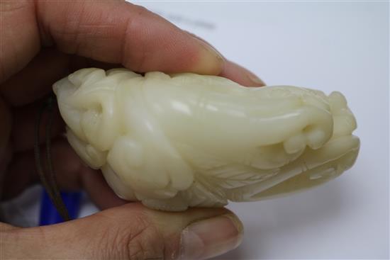A Chinese white jade carving of a boy clambering on a finger citron, 7.7cm